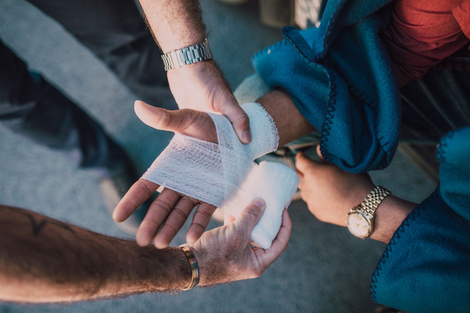 Hands practising bandaging for first aid refresher training